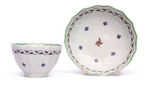 Lowestoft fluted tea bowl and saucer circa 1790, decorated in polychrome with Chantilly sprig design