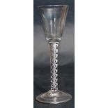 Wine glass probably 18th century, the plain rounded funnel bowl raised on an air twist stem, 17cm