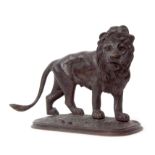 Japanese bronze model of a lion standing on an oval base, 16cm long