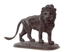 Japanese bronze model of a lion standing on an oval base, 16cm long