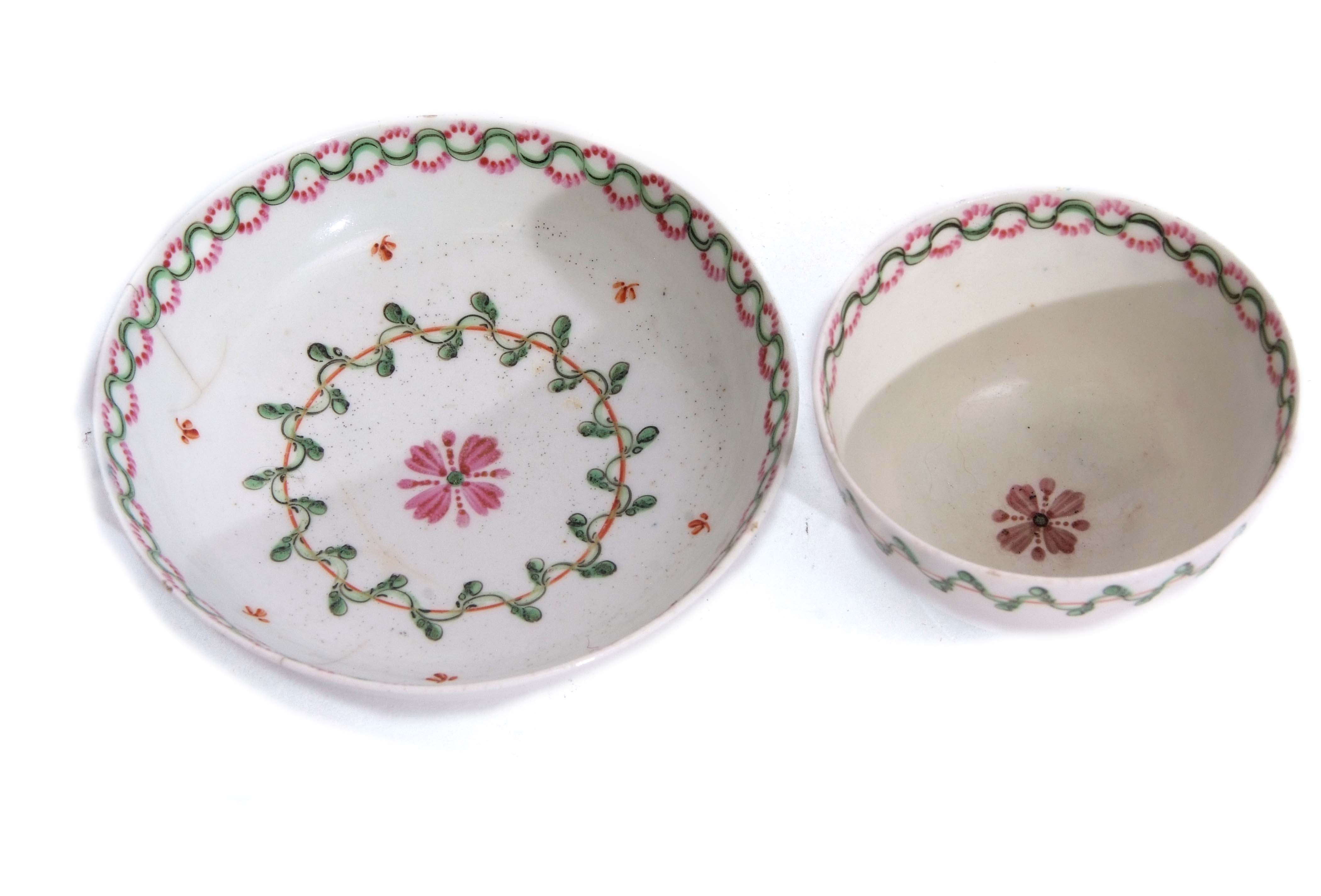 Lowestoft tea bowl and saucer circa 1780 with a polychrome design in green and pink enamel, the