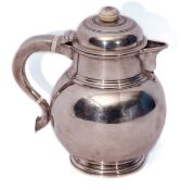 George V lidded hot water jug, the hinged and domed cover with ivory finial to a plain neck and C-