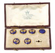 Cased set of six (of seven) yellow metal and enamelled waistcoat buttons, each of circular form with