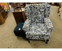 BLACK AND WHITE FLORAL UPHOLSTERED WING FIRESIDE CHAIR TOGETHER WITH A TARTAN COVERED SQUARE FOOT