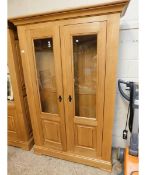 OAK FRAMED TWO GLAZED PANELLED DOOR BOOKCASE WITH ADJUSTABLE SHELVES