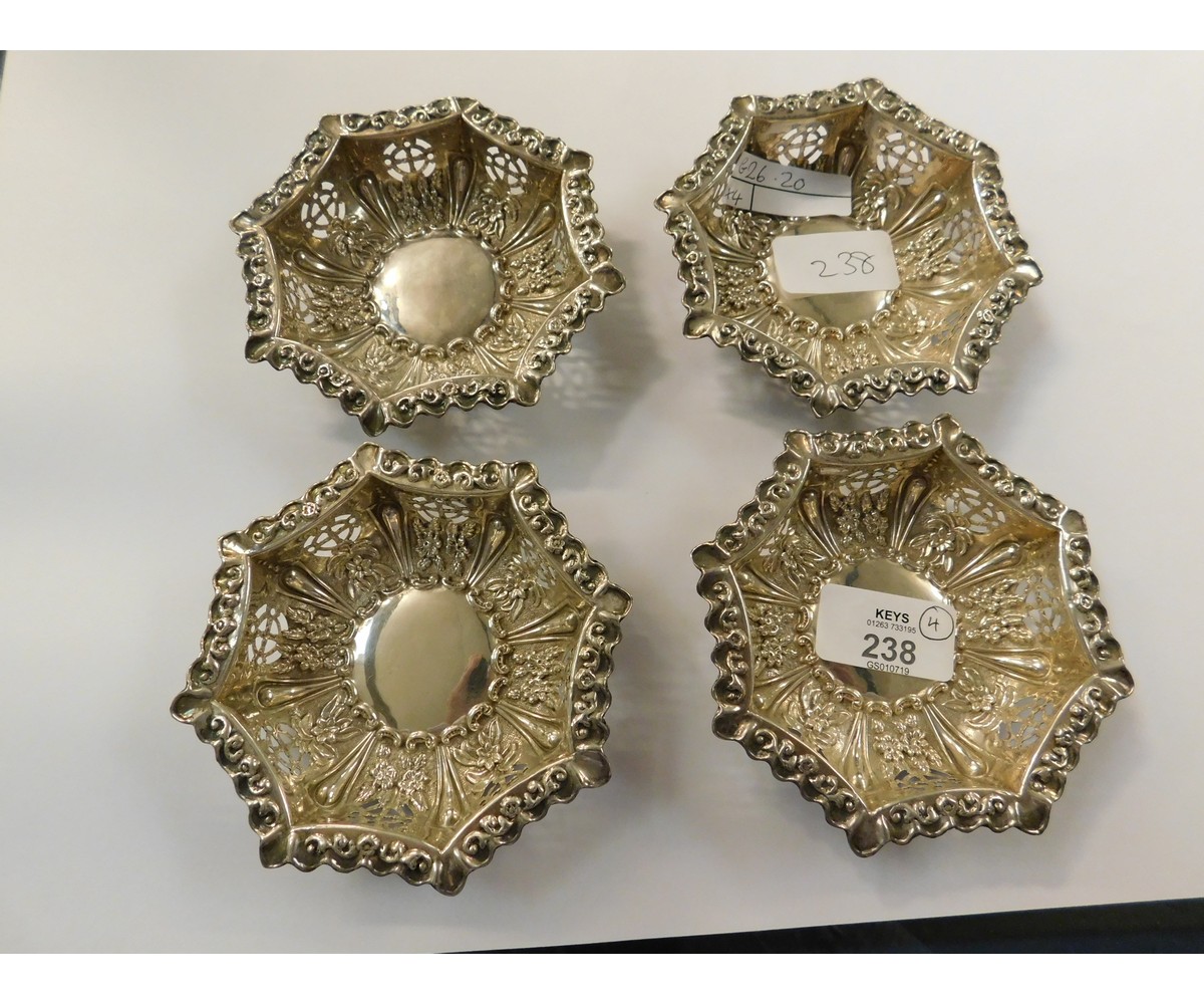 SET OF FOUR HEXAGONAL PIERCED SILVER PIN DISHES WITH DECORATIVE PRESSED DESIGN