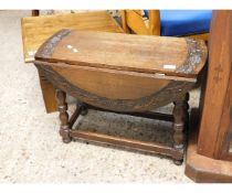 SMALL OAK CIRCULAR DROP LEAF COFFEE TABLE WITH CARVED GRAPE AND VINE DETAIL TO TOP ON TURNED LEGS