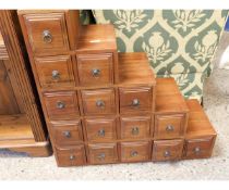 EASTERN HARDWOOD STEPPED 15-DRAWER CABINET WITH RINGLET HANDLES
