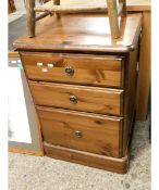 STAINED PINE FRAMED THREE FULL WIDTH DRAWER BEDSIDE CABINET WITH RINGLET HANDLES