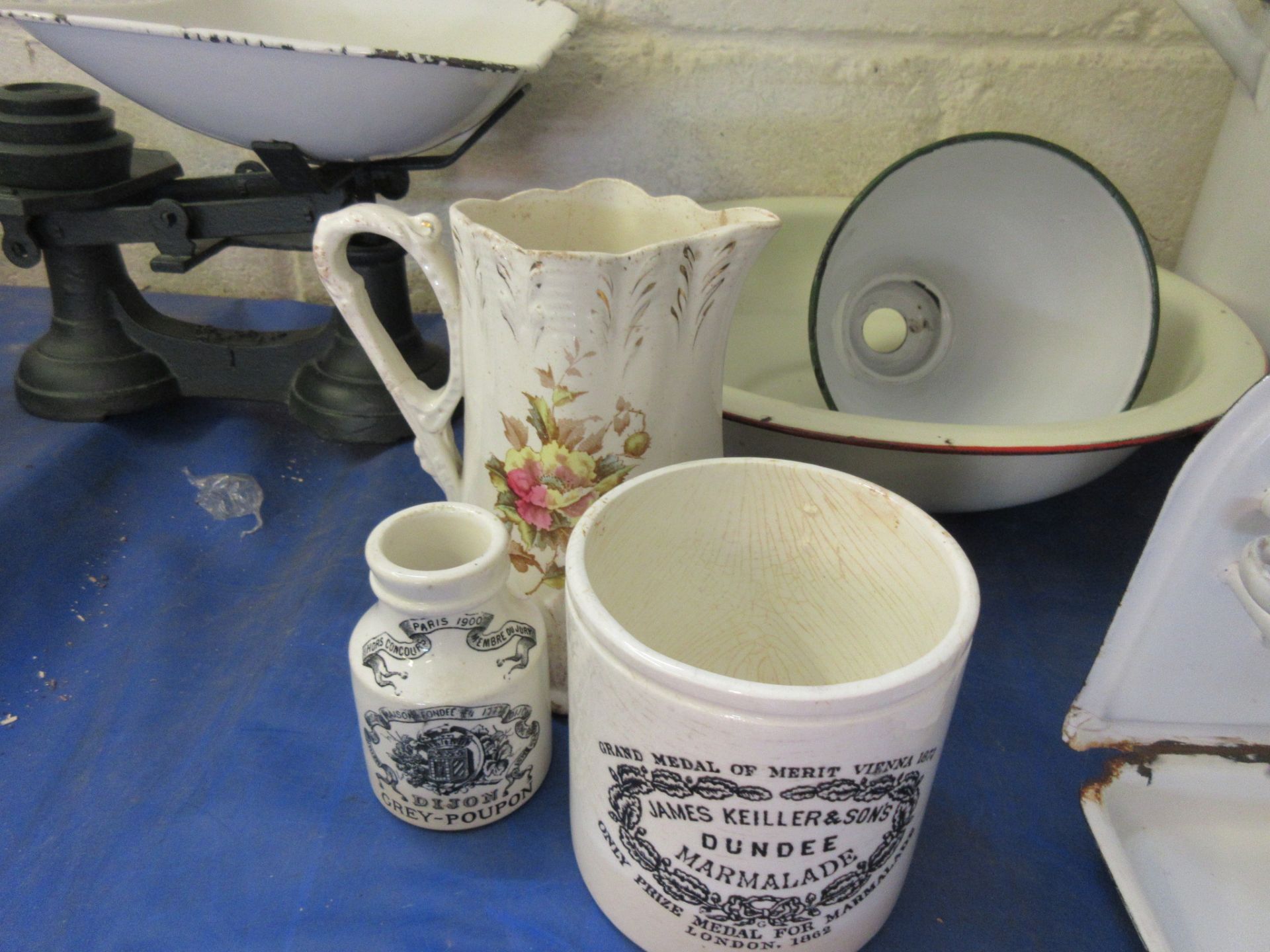 A marmalade pot together with a Dijon mustard bottle and a floral milk jug