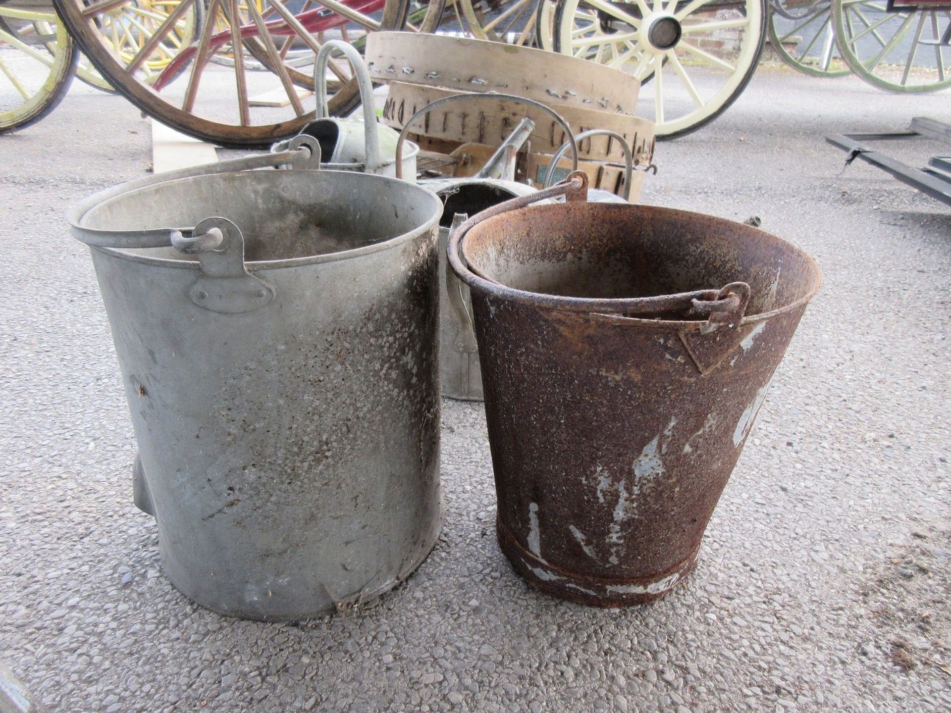 A metal fire bucket together with a galvanised pot or boiler