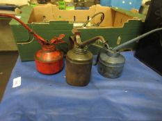 Three various oil cans