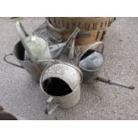 Three various galvanised watering cans