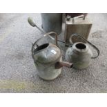 Two galvanised watering cans