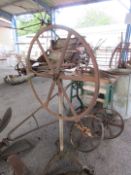 A large metal turning handle on stand stamped Wolseley