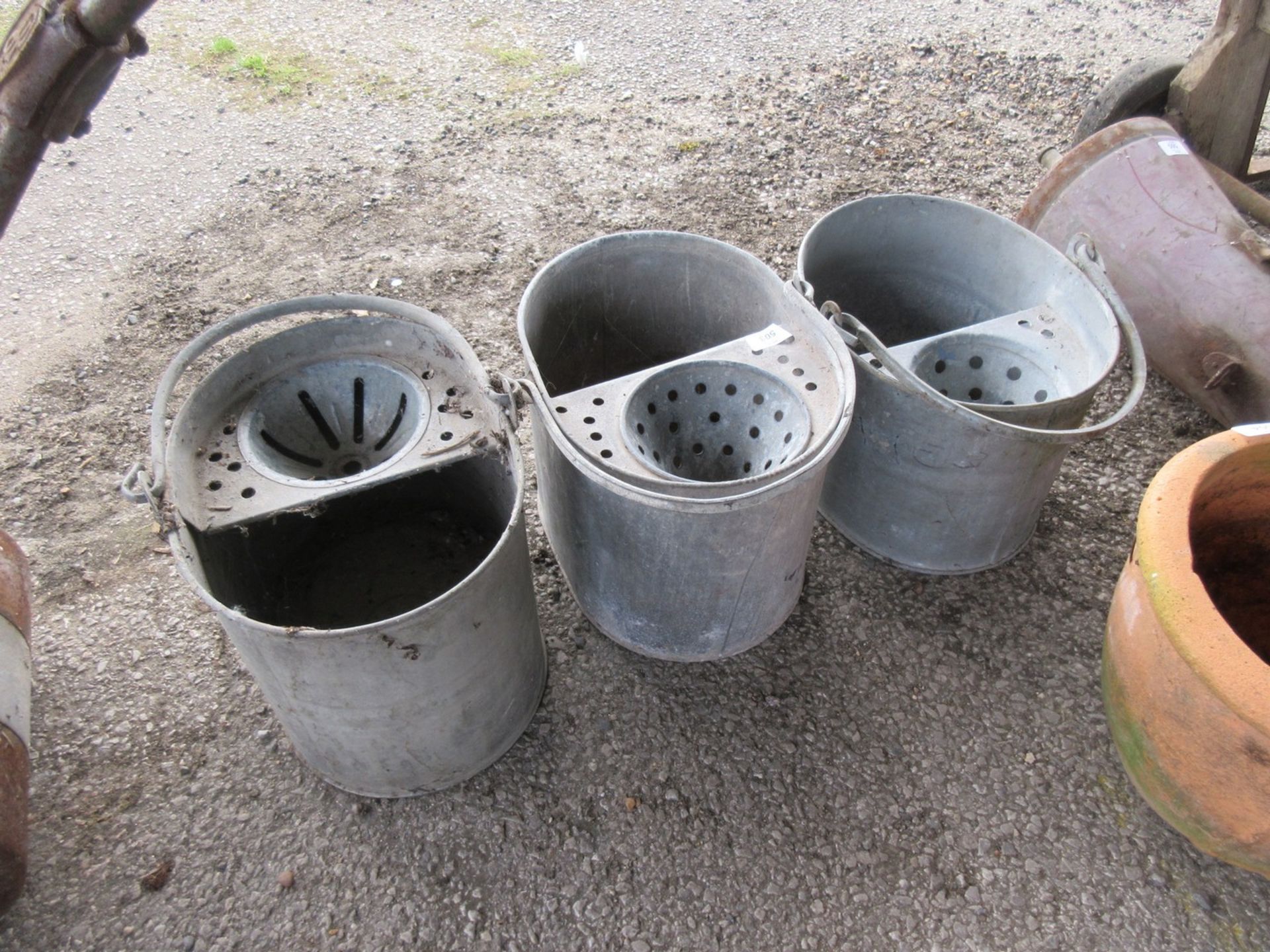 Three galvanised mop buckets