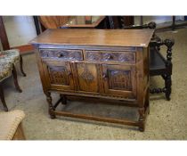 OAK FRAMED SMALL PROPORTIONED SIDEBOARD WITH TWO DRAWERS OVER TWO CARVED PANELLED CUPBOARD DOORS