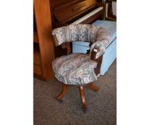 VICTORIAN MAHOGANY FRAMED DESK CHAIR WITH FLORAL UPHOLSTERY ON A QUATREFOIL BASE WITH PORCELAIN