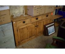 VICTORIAN PINE FRAMED DRESSER BASE FITTED WITH THREE DRAWERS OVER TWO CUPBOARD DOORS WITH TURNED