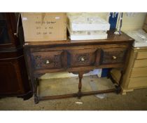 OAK FRAMED SIDEBOARD WITH THREE DRAWERS WITH CARVED DETAIL ON TURNED LEGS WITH BRASS KNOB HANDLES