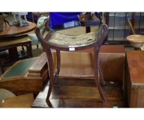 EDWARDIAN MAHOGANY FRAMED CONCAVE TOP STOOL WITH RAIL SIDES AND SHAPED LEGS SUPPORTED ON A TURNED
