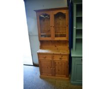 PINE FRAMED DRESSER, THE TOP FITTED WITH TWO GLAZED DOORS, THE BASE WITH TWO DRAWERS OVER TWO