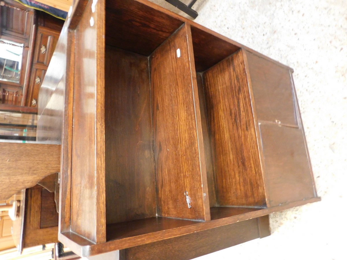 OAK FRAMED NARROW BOOKCASE WITH TWO OPEN SHELVES OVER PANELLED CUPBOARD DOORS