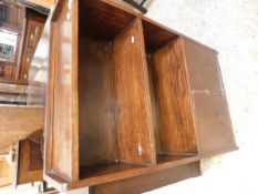 OAK FRAMED NARROW BOOKCASE WITH TWO OPEN SHELVES OVER PANELLED CUPBOARD DOORS