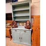 TURQUOISE PAINTED DRESSER WITH ADJUSTABLE SHELVES, THE BASE FITTED WITH TWO DRAWERS OVER TWO