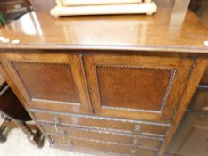 EARLY 20TH CENTURY OAK FRAMED LOWBOY TYPE CABINET WITH TWO PANELLED DOORS OVER THREE FULL WIDTH