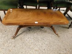 MAHOGANY COFFEE TABLE ON QUATREFOIL BASE WITH BRASS CASTERS