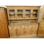 GOOD QUALITY WAXED PINE DRESSER, THE TOP FITTED WITH FOUR GLAZED DOORS, THE BASE WITH FOUR DRAWERS