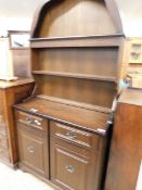 MID-20TH CENTURY OAK FRAMED ARCH TOP DRESSER, THE TOP WITH TWO FIXED SHELVES, THE BASE WITH TWO