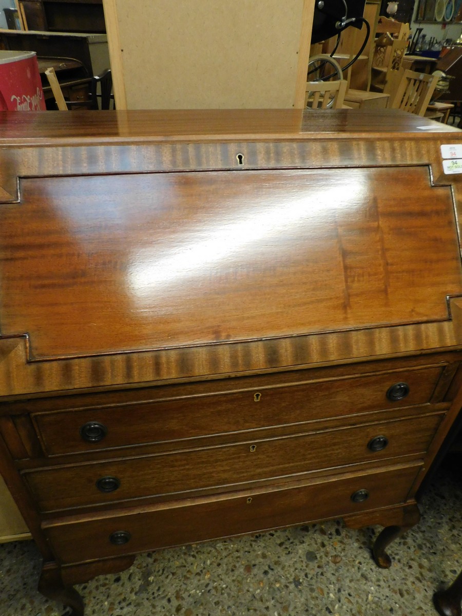 TEAK FRAMED DROP FRONTED BUREAU WITH THREE FULL WIDTH DRAWERS WITH RINGLET HANDLES RAISED ON PAD