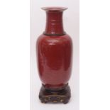 Chinese sang de boeuf vase, the ovoid body with slender neck, the vase on a wooden base, 50cm high