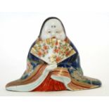 Oriental model of a lady holding a fan decorated in polychrome enamels, 10cm high