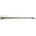 Bamboo stick with claw to one end and strap