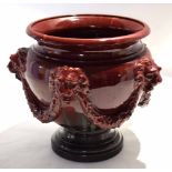 Large ruby coloured pottery jardiniere by Clement Massier, the pottery body modelled with lions