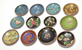 Group of 12 cloisonne small dishes all decorated in typical fashion with either floral designs or