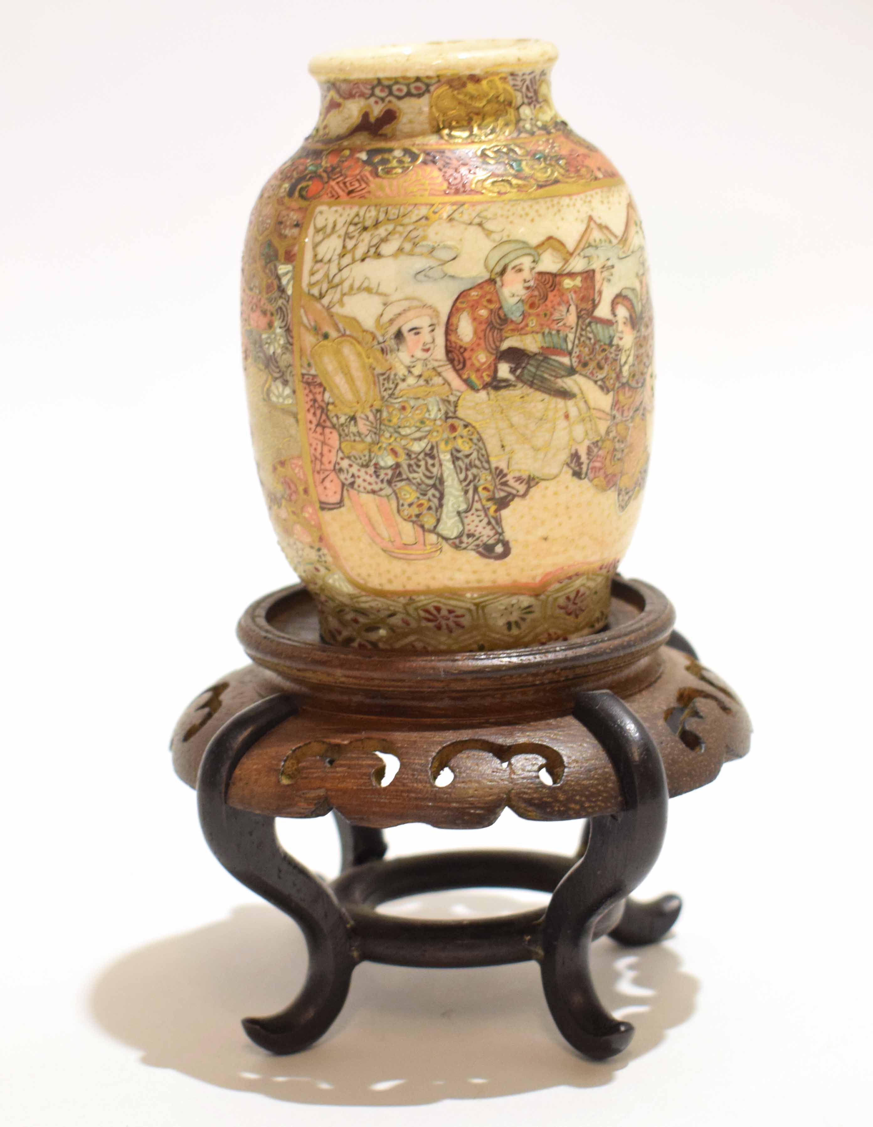 Satsuma earthenware vase with two panels, one with figures in a garden setting with a panel of