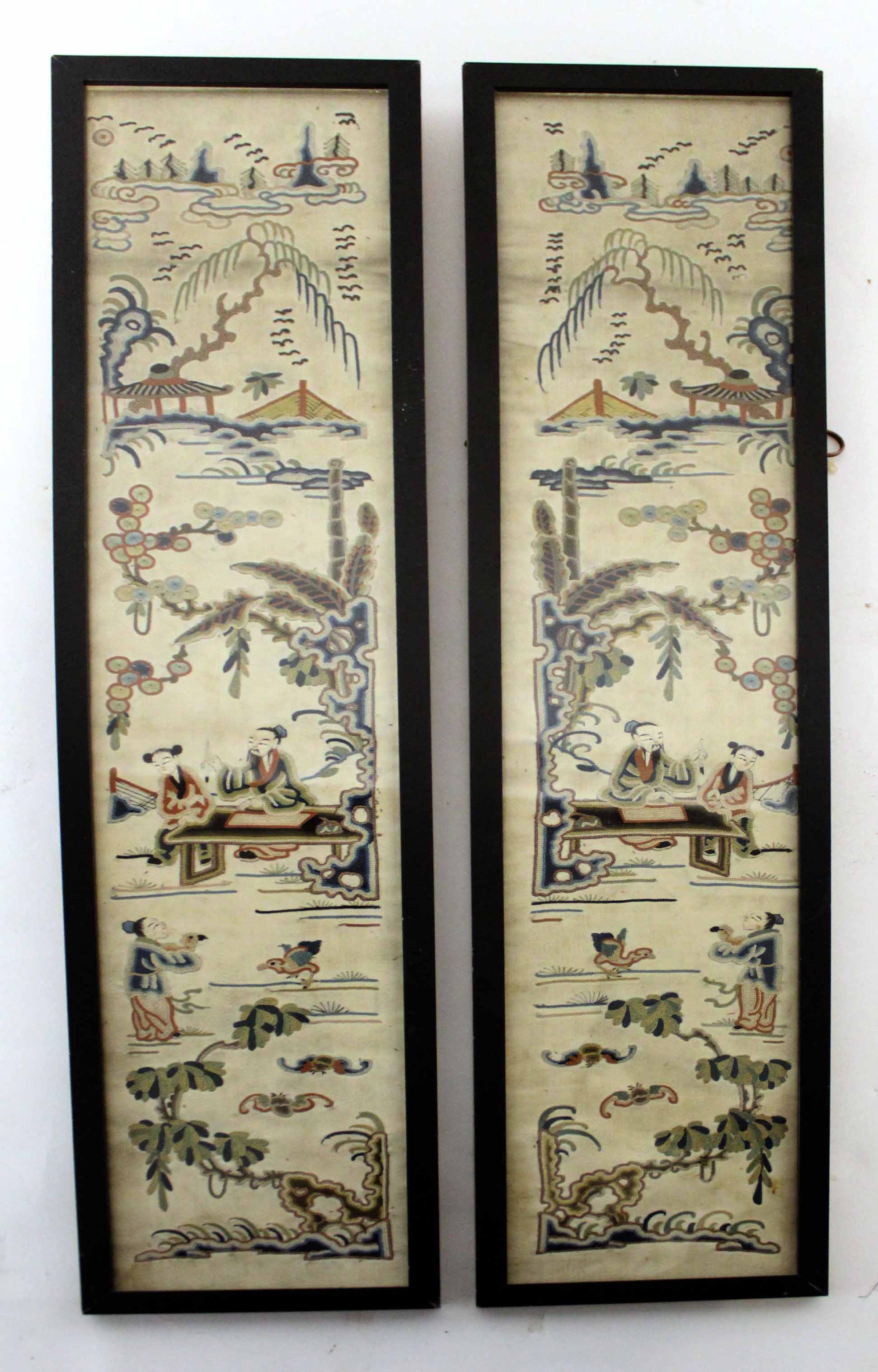 Pair of Chinese embroidered panels on silk in black frames, 54cm long (2)