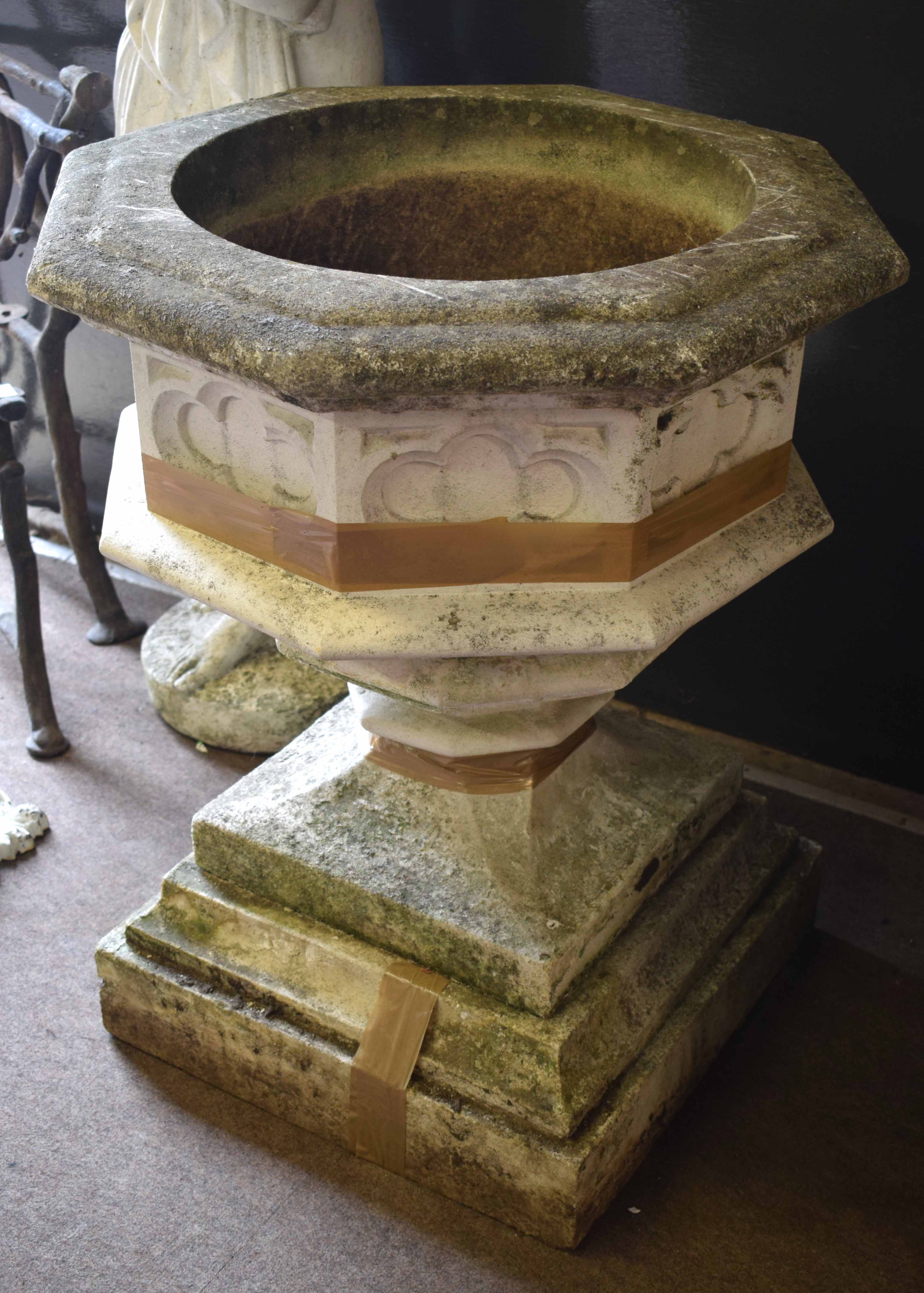 Weathered composition font type garden urn of octagonal pedestal form, 76cm high