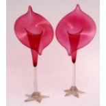 Pair of cranberry glass jack pulpit vases with a clear stem and a spread five footed base, 35cm