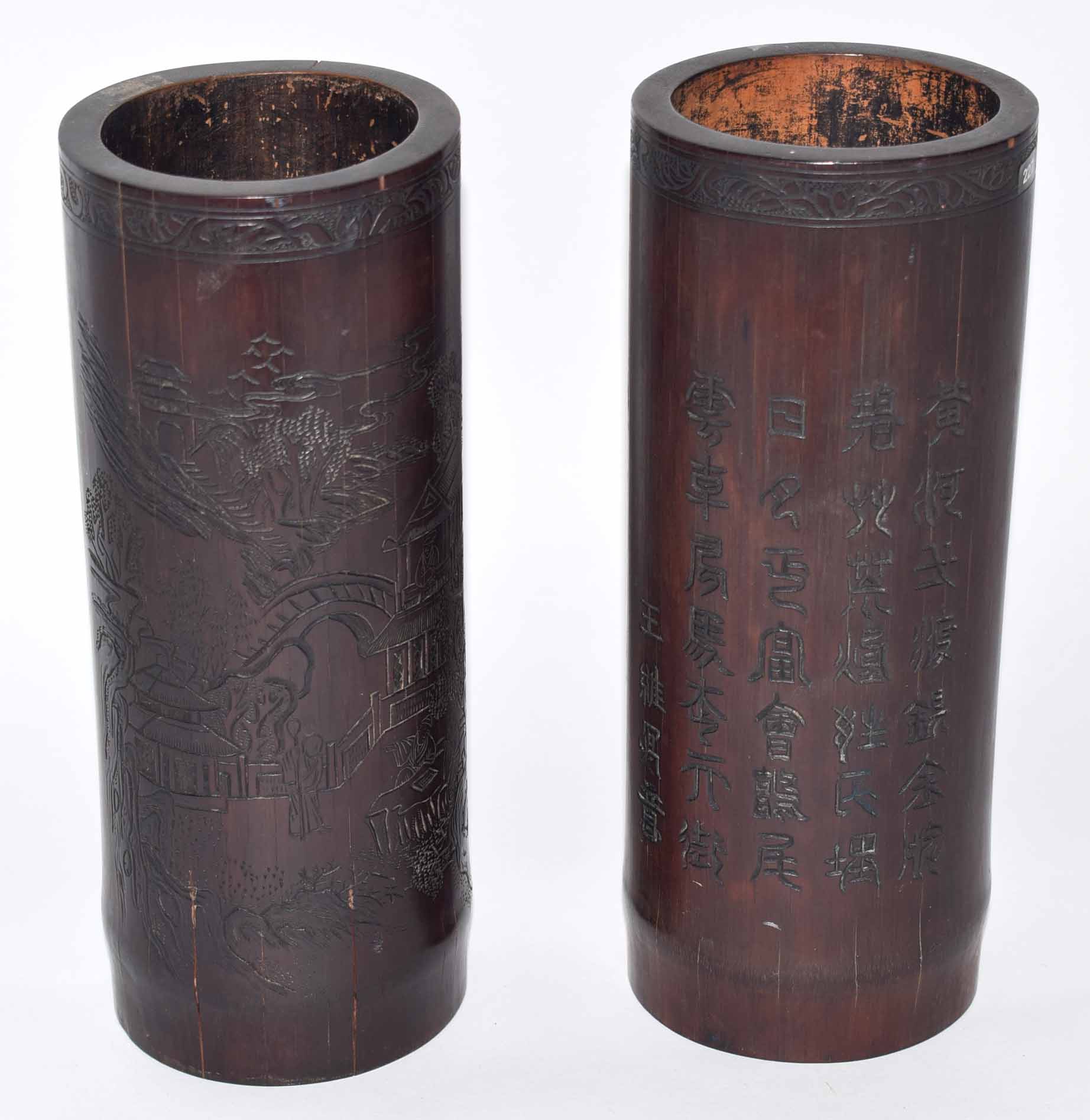 Two Chinese wooden brush pots decorated with landscape scenes with inscription verso, together