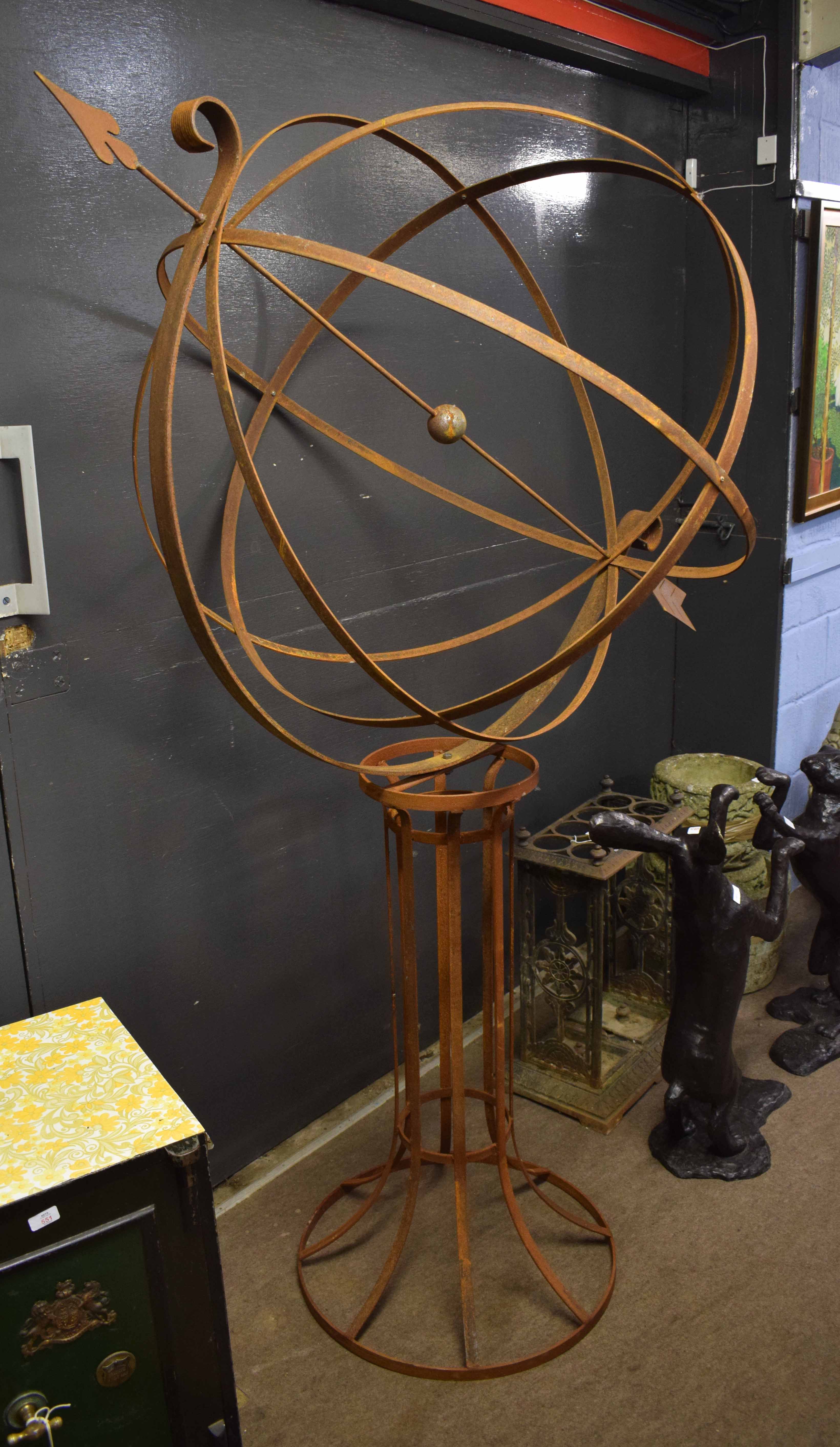 Unusual weathered and rusted metal weathervane, globe form with arrow pointer, raised on spreading