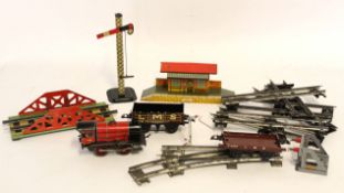 Box containing various Hornby and Mettoy 00 gauge train and accessories including locomotive and