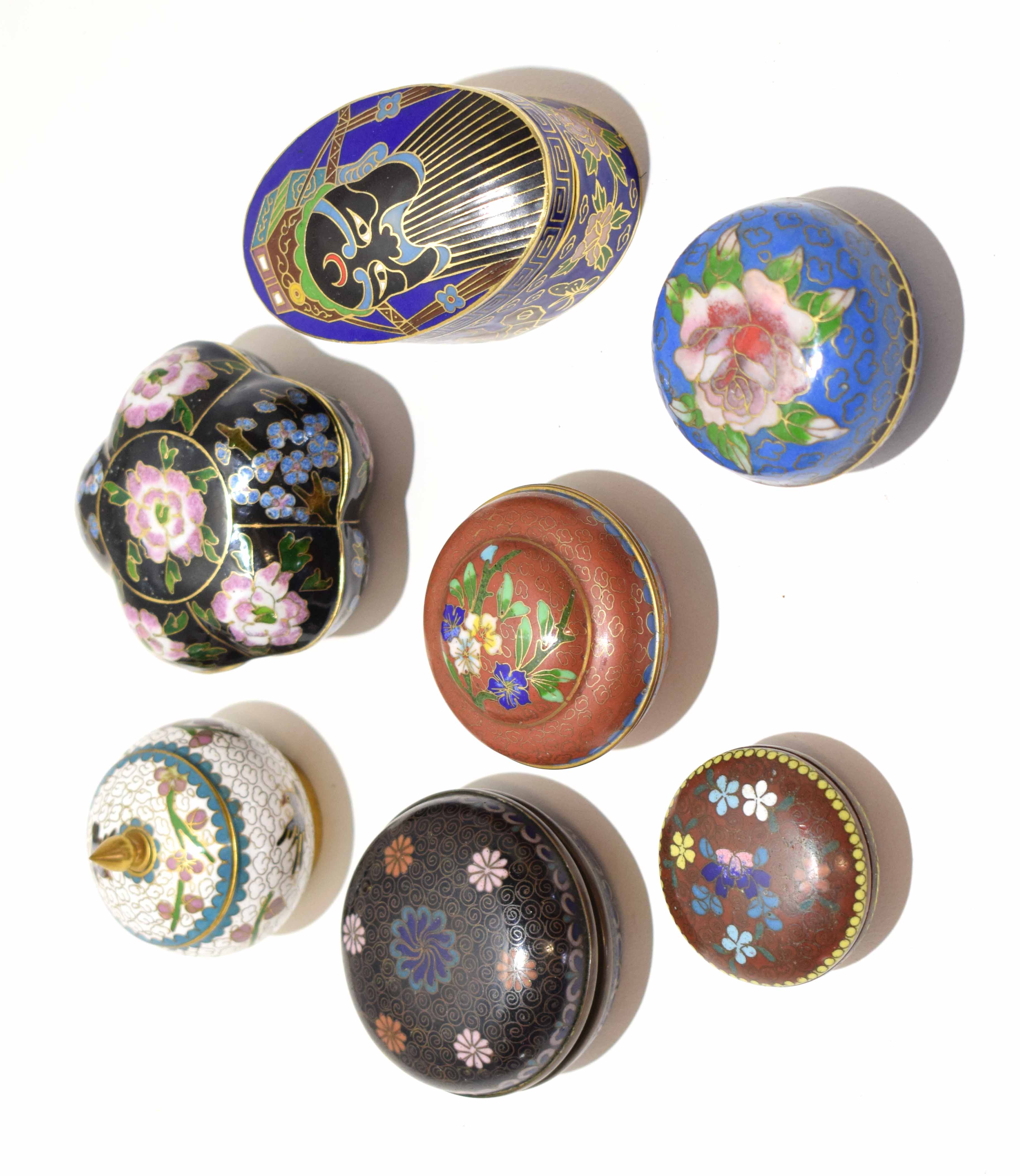 Group of cloisonne decorated boxes of various shapes and forms, all with typical enamel