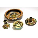 Collection of Gouda pottery wares comprising a large bowl, candlestick, two candlestick holders
