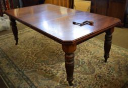 Late 19th century American walnut wind-out extending dining table with canted corners, raised on