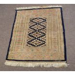 Modern small prayer rug decorated predominantly in cream and blue, with repeating diamond centre